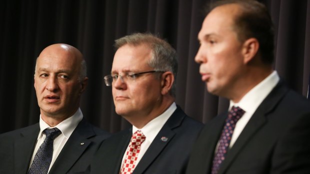 Mr Aristotle pictured with then-social services minister Scott Morrison and Immigration Minister Peter Dutton at a joint press conference in September last year.