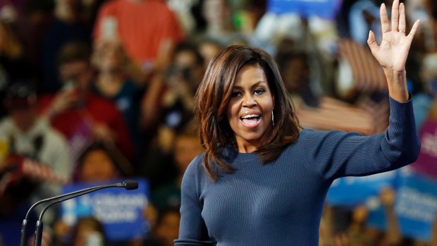 First lady Michelle Obama arrives to a cheering crowd during a campaign rally for Democratic presidential candidate Hillary Clinton.