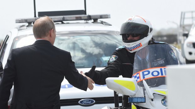 Russian President Vladimir Putin thanks officers as he leaves Brisbane.