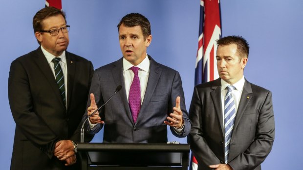 The greyhound ban is weighing heavily on Deputy Premier Troy Grant, left, and Premier Mike Baird. 