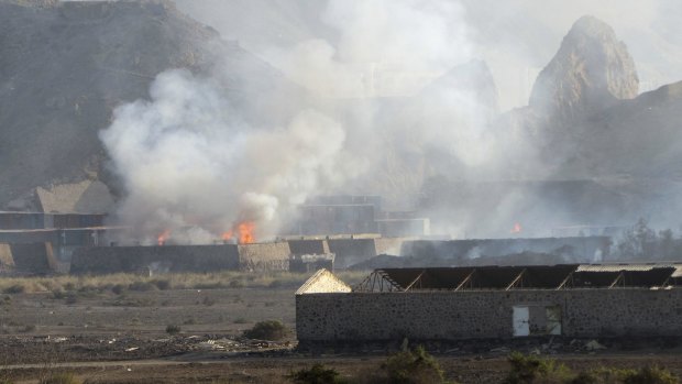 Buildings at the Jabal al-Hadid military camp burn after air strikes in Aden, Yemen, on Saturday.