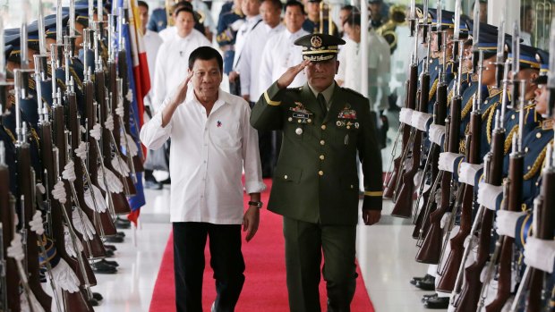 Philippine President Rodrigo Duterte, left, salutes with Philippine military chief Lt. Gen. Ricardo Visaya at Manila's International Airport.