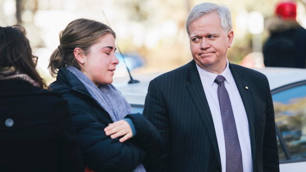 ANU vice-chancellor Brian Schmidt comforts a student during a protest held outside the university's chancellory in response to the report into sexual harassment and assault at universities.