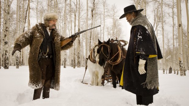 Bounty hunters Kurt Russell and Samuel L. Jackson face off in <i>The Hateful Eight</i>.