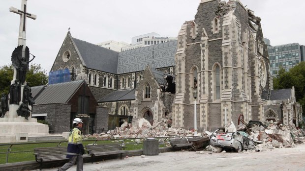 A relief worker walks past the earthquake-damaged Christchurch Cathedral in Christchurch on February 26, 2011. 
