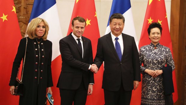 French President Emmanuel Macron, second from left, and his wife Brigitte Macron, left, pose with Chinese President Xi Jinping and his wife Peng Liyuan in Beijing on Monday.