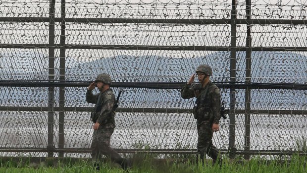 South Korean army soldiers salute as they patrol along the barbed-wire fence in South Korea's Paju, near the border with North Korea on Monday.
