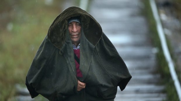 A Syrian migrant walks alone through rain and low temperatures to make his way to Hungary from Serbia near the town of Kanjiza on Friday.