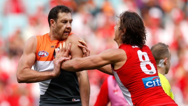 Fiery clash: Kurt Tippett and Shane Mumford wrestle during the 2016 AFL First Qualifying Final between the Sydney Swans and the GWS Giants at ANZ Stadium.