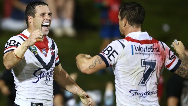 Centre of the action: Gordon celebrates his late try with Mitchell Pearce.