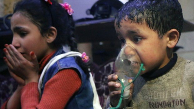 This image released early Sunday, April 8, 2018 by the Syrian Civil Defense White Helmets, shows a child receiving oxygen through respirators following an alleged poison gas attack in the rebel-held town of Douma.