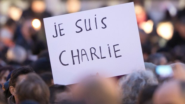 Signs saying "Je suis Charlie" are held up as crowds gather at Place de la Republique in protest against the killings at the offices of Charlie Hebdo in  January 2015.