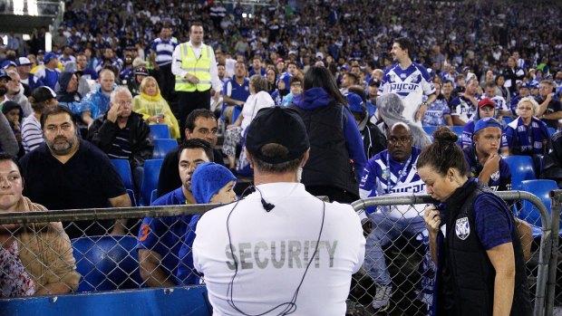 Drama: Security guards look on after a bottle was thrown from the Belmore Sports Ground crowd on Monday night. Fairfax Media does not suggest anyone pictured was involved. 