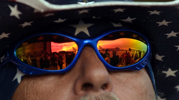 Air Force One is reflected in a pair of sunglasses as President Donald Trump arrives to speak at his "Make America Great Again Rally" at Orlando-Melbourne International Airport.