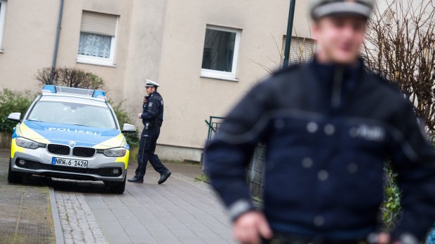 Police officers in front of a house in Duesseldorf, where a German magazine says two people with possible links to the Brussels attacks were arrested on Friday.