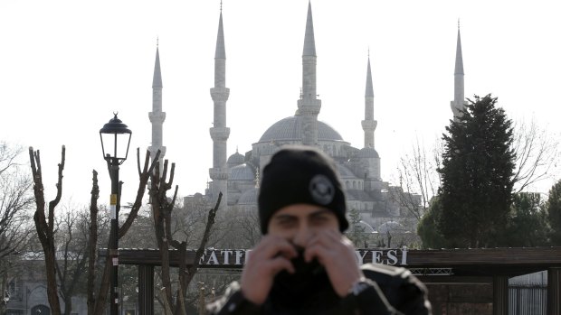 A policeman stands in front of the Blue Mosque in the historic Sultanahmet district after the explosion.