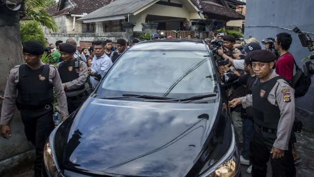 Indonesian police escort the car which Schapelle Corby is in as she prepares for deportation from Indonesia on May 27.