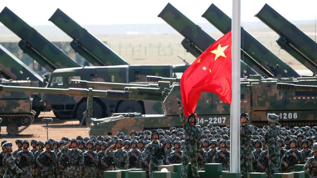 People's Liberation Army troops perform a flag-raising ceremony.
