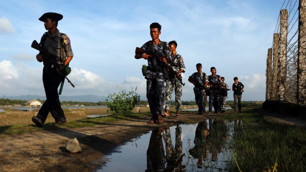 Myanmar police officers patrol the border between Myanmar and Bangladesh in Maungdaw, Rakhine State.