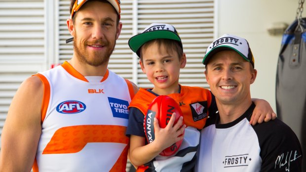 GWS boy: Oliver Winterbottom with dad Mark (right) and Giants ruckman Shane Mumford (left)