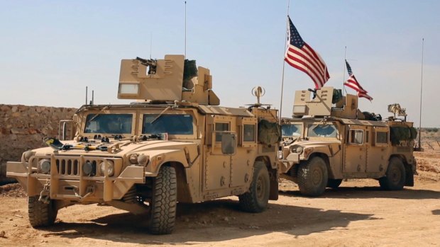US forces take up positions on the outskirts of the Syrian town, Manbij.