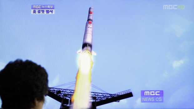 A South Korean woman watches a TV news report showing a computer generated image of North Korea's long-range rocket at Seoul train station in Seoul in 2012.