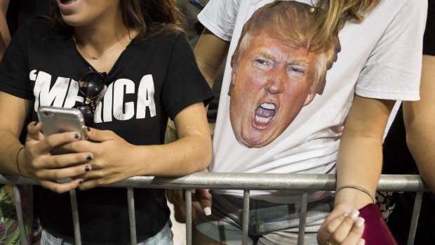 All the rage: a woman wears a shirt with the likeness of Donald Trump.