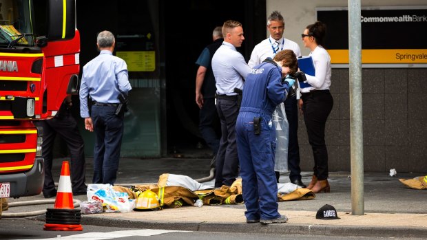 Evidence is recorded at the scene of the Commonwealth Bank fire in Springvale.