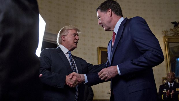 President Donald Trump greets then-FBI director James Comey with a handshake back in February.