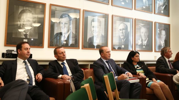 Former prime minister Tony Abbott listens to Prime Minister Malcolm Turnbull at the joint party room meeting at Parliament House on Tuesday.