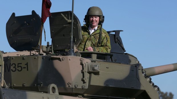 Defence Industry Minister Christopher Pyne, in the turret of an armoured vehicle at Victoria's Puckapunyal army base recently.