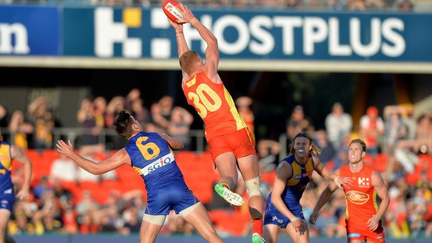 Gold Coast's Peter Wright takes a mark before going on to kick the winning goal.