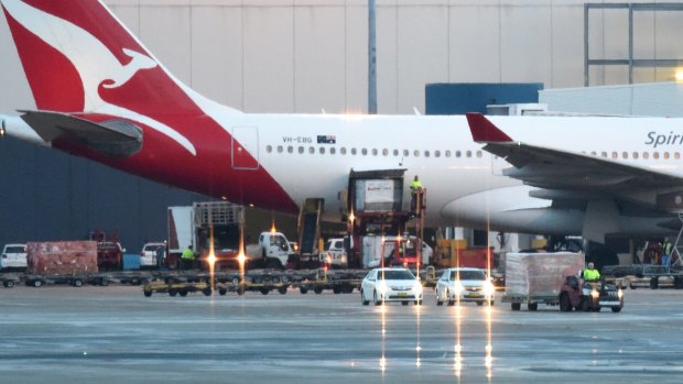 A container believed to be carrying the bodies of Myuran Sukumaran and Andrew Chan is escorted from the tarmac following their arrival in Sydney.