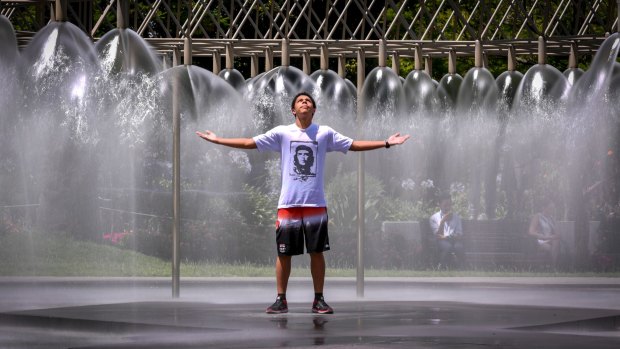 English student Keanu Audabram from New Caledonia cools down at the fountain on Spring Street.