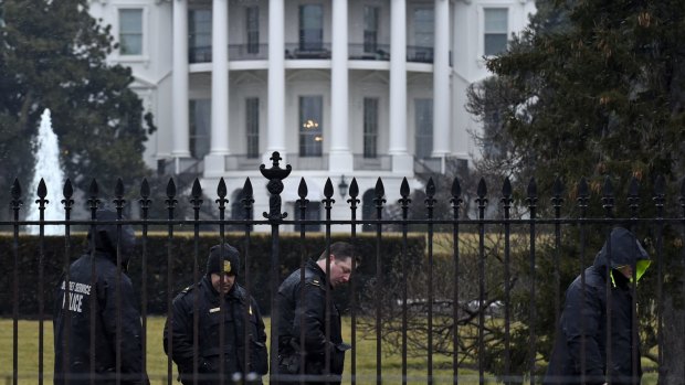 Secret service officers search the grounds of the White House after a small drone was found.