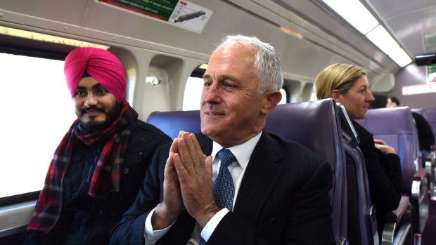 Prime Minister Malcolm Turnbull (right) speaks to a man who had missed the earlier train but thought it was lucky because he met the Prime Minister as they catch a train from Sydney city to Emu Plains in the seat of Lindsay in Sydney, Monday, May, 30, 2016. Pool Photo: Tracey Nearmy / AAP POOL