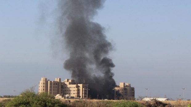 Smoke rises following an explosion that hit Hotel al-Qasr where Cabinet members and other government officials are staying, in the southern port city of Aden, Yemen.