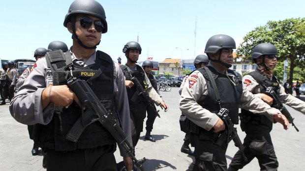 High alert: Police officers patrol New Year's celebrations in Bali on Thursday.