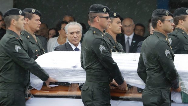 President Michel Temer attends the arrival ceremony of the coffins.
