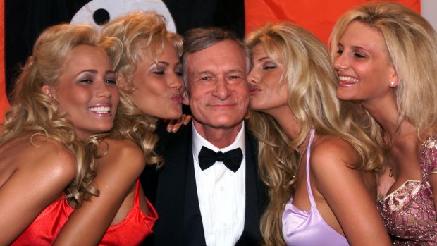 Hugh Hefner basks in the kisses of his playmates in Cannes, in 1999. 