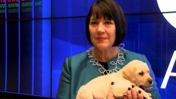 National Vet Care chairwoman Susan Forrester with a Labrador puppy on the floor of the Australian Securities Exchange in Sydney to mark the listing.