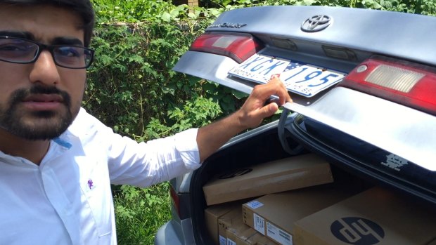 Vocational education salesman "Hamza"  and his car full of laptops.