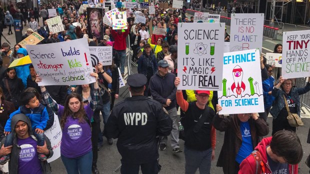 Demonstrators pass a policeman in the March for Science in New York last week.