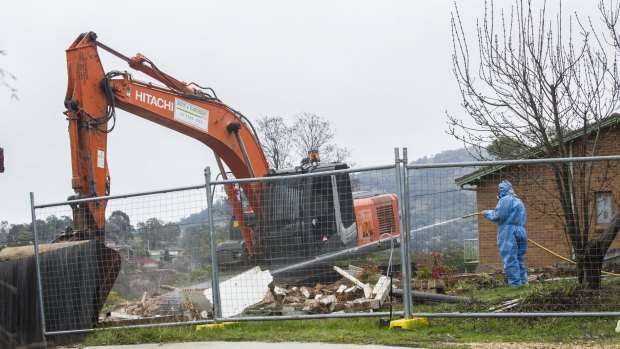 Workers demolish a Mr Fluffy home in Farrer.