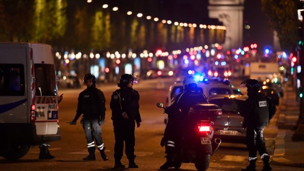 Police officers secure the area after a gunman opened fire on Champs Elysees.