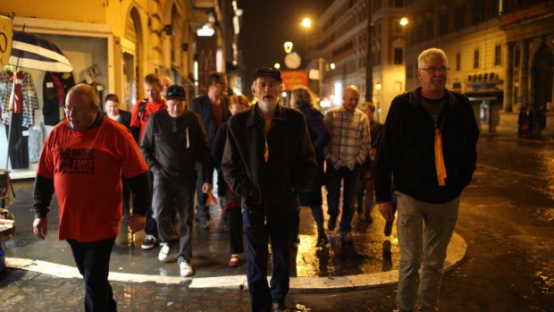 Abuse survivors walk towards the Hotel Quirinale to attend the hearing of Cardinal Pell's evidence in Rome.