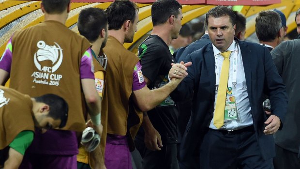 Job done: Ange Postecoglou congratulates his players after another Asian Cup victory.