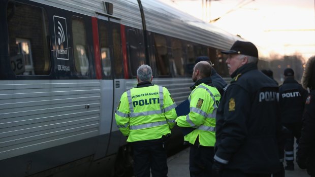 Danish policemen prepare to board a train from Germany to check passengers' identity papers.