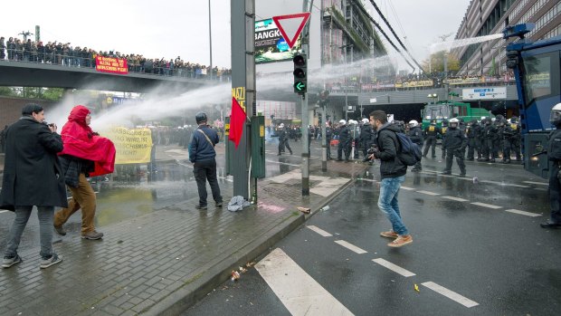 Water cannons are deployed to prevent clashes between demonstrators.