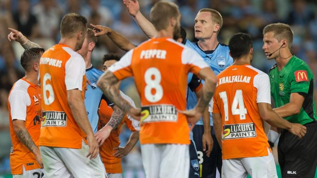 Look at the screen: Sydney FC players point to the replay after a scuffle broke out following the spitting incident.